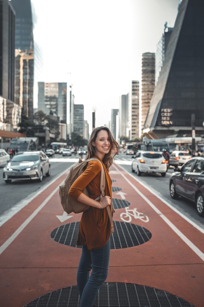 woman standing on middle of road traveling